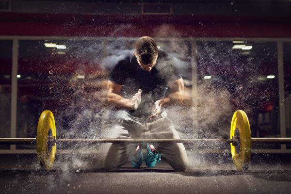 man kneeling powder barbell deadlift hang clean