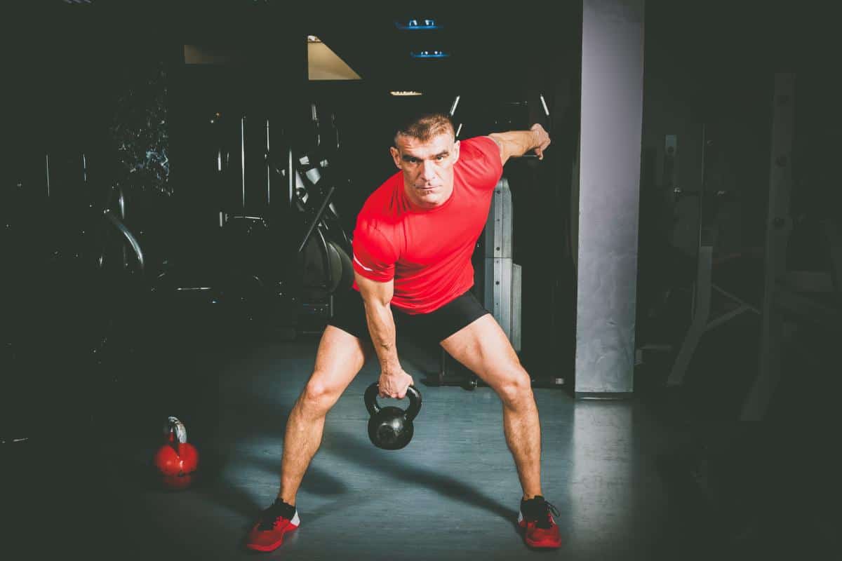 Kettle bell workout in the gym Man with kettle bell Kettle bell swing