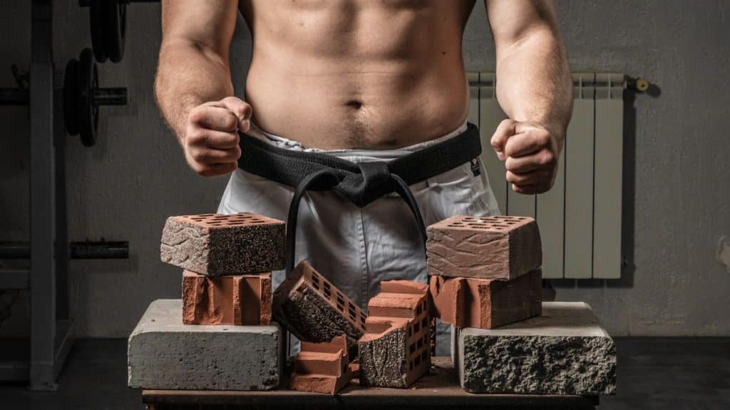 Muscular Man Breaking Bricks