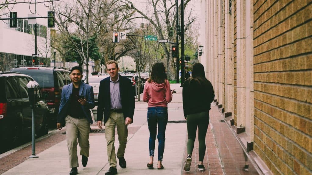 How Can NEAT Help You Lose Weight? two men and women walking outside and talking.